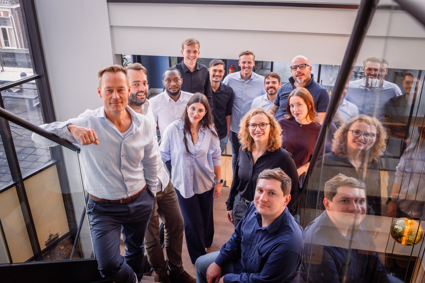 The HULO team on the stairs of the office in Leeuwarden, looking up at the camera.